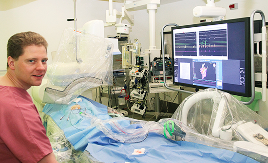 Dr. Martin Seifert in the examination room of the HKL3 laboratory. An EIZO RadiForce LS580W is attached to the operating room stoplight.